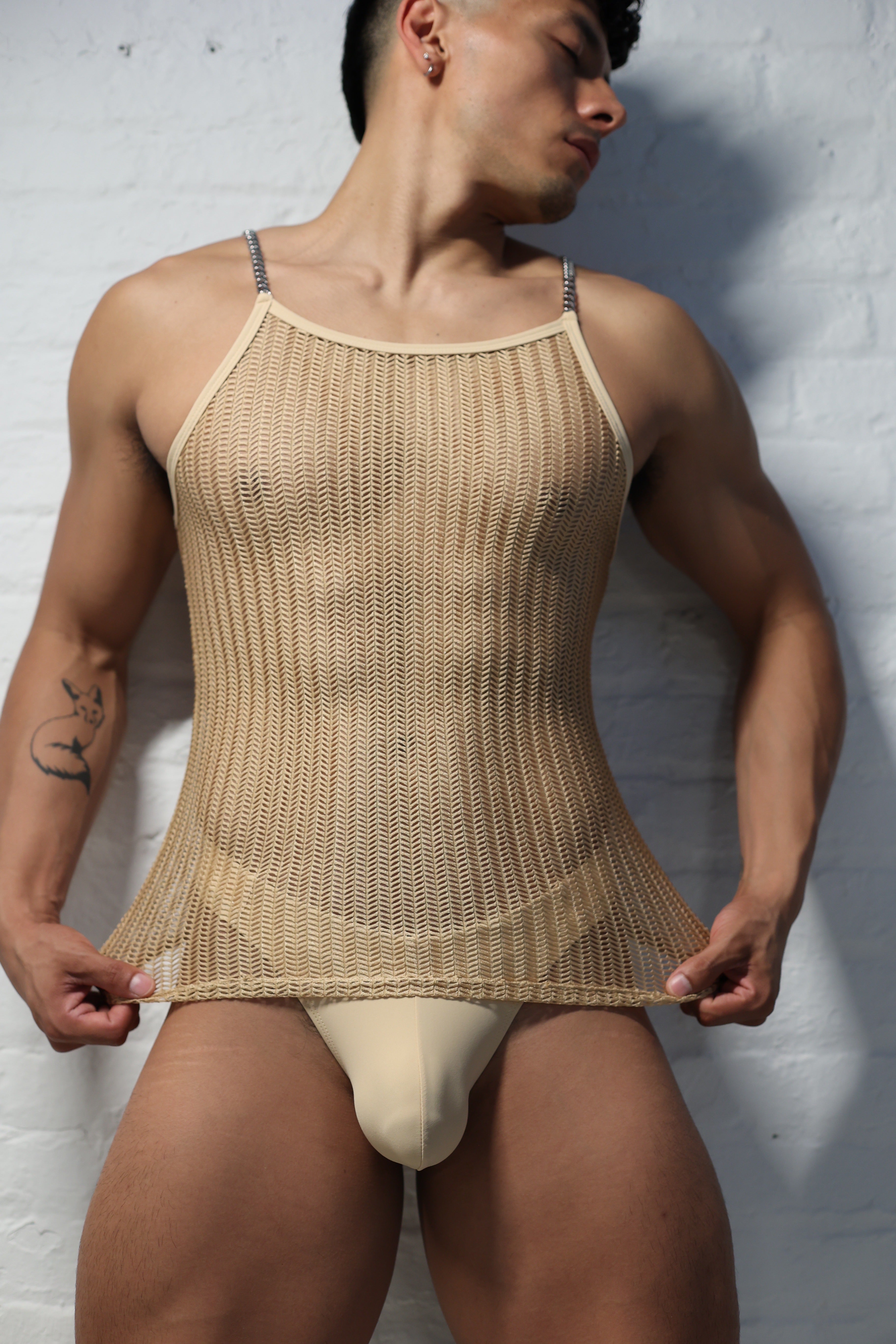 Model wearing natural nude netted tank top with metal chain shoulder straps from Fabian Divani Vers collection