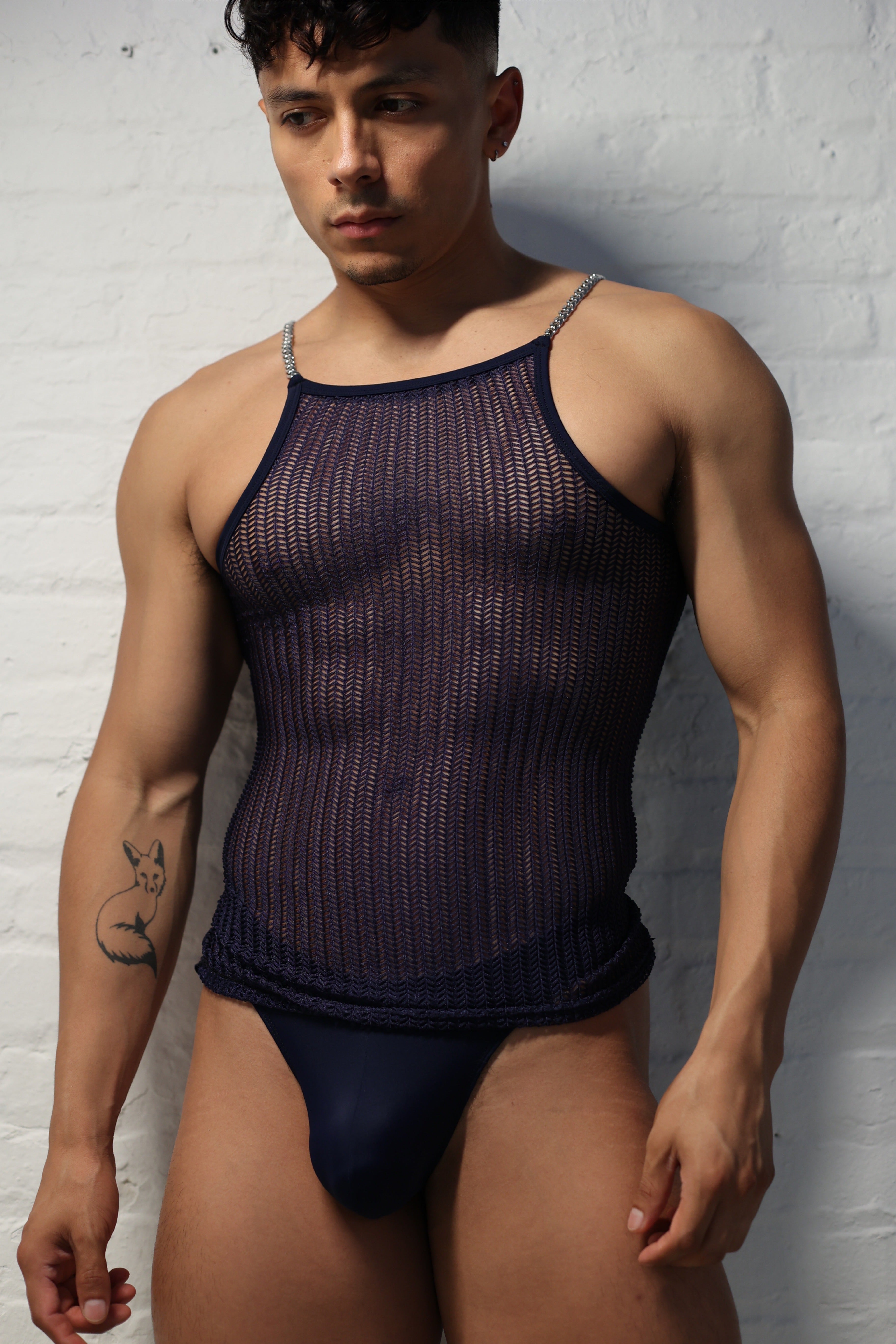 Model wearing midnight netted tank top with metal chain straps from Fabian Divani Studio showing textured pattern detail