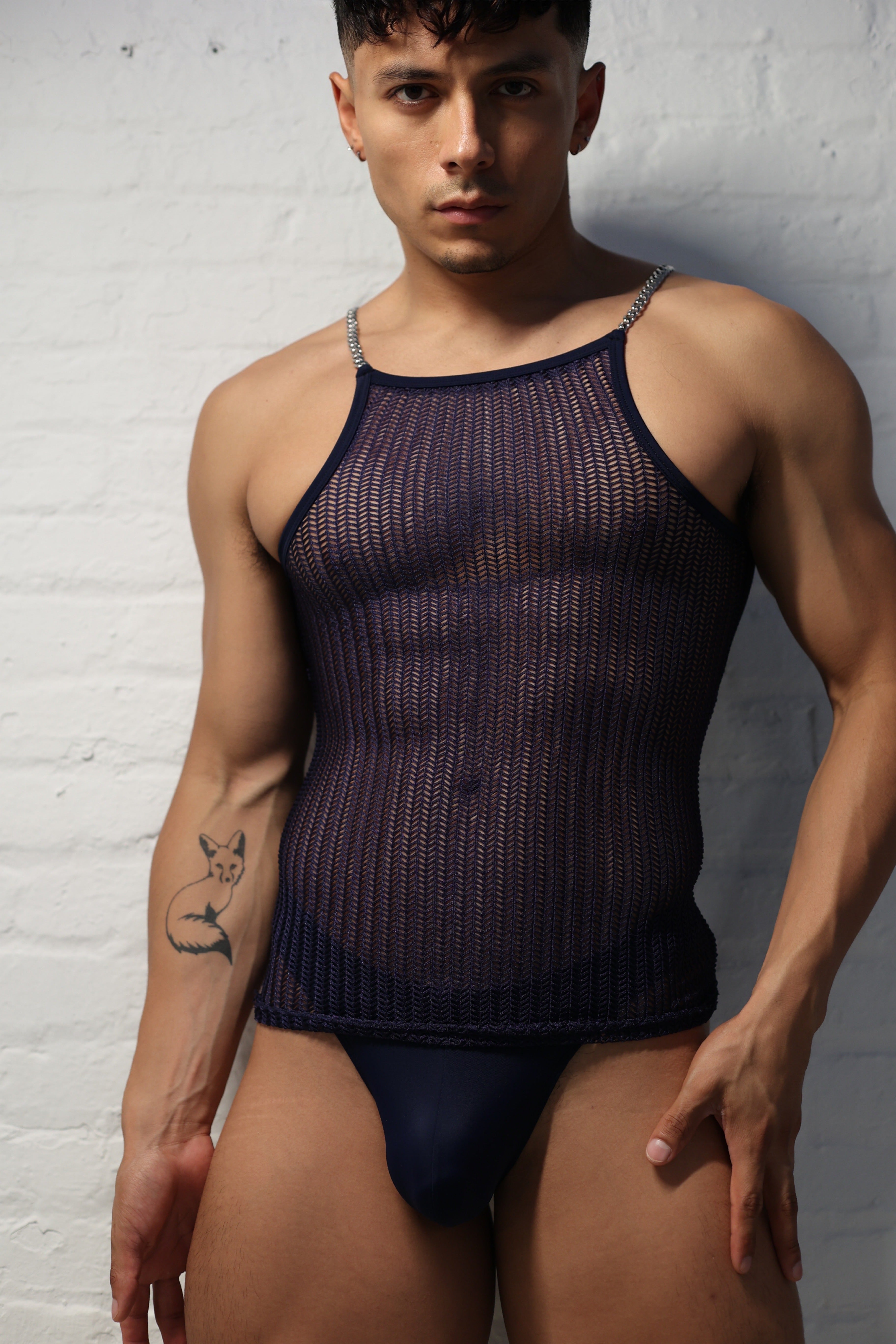 Model wearing midnight netted tank top with metal chain straps from Fabian Divani Studio showing textured pattern detail