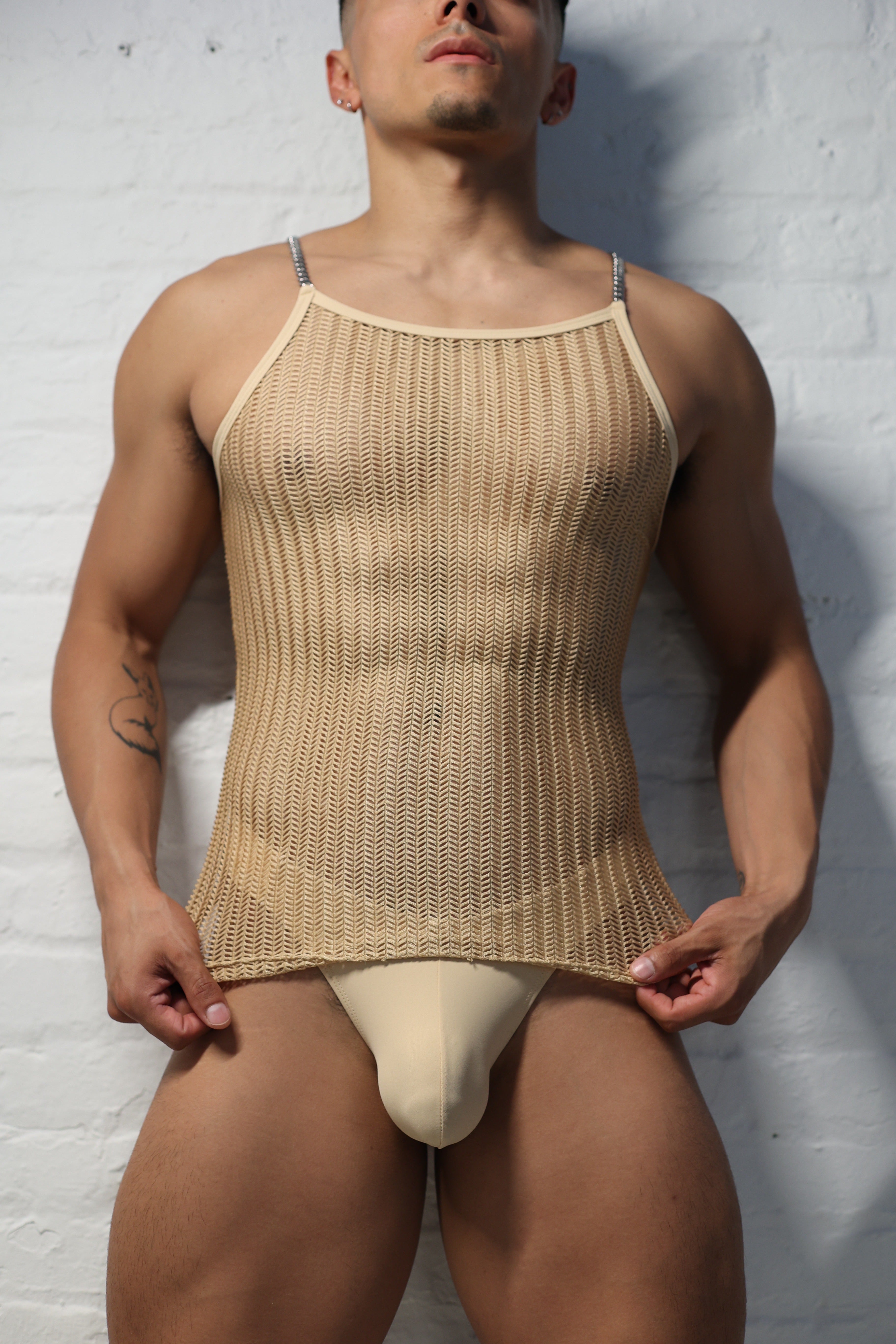 Model wearing natural nude netted tank top with metal chain shoulder straps from Fabian Divani Vers collection