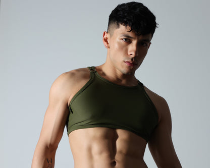 Fabian Divani modeling a sheer olive green mesh crop top —handmade by Fabi —posed in front of a white wall